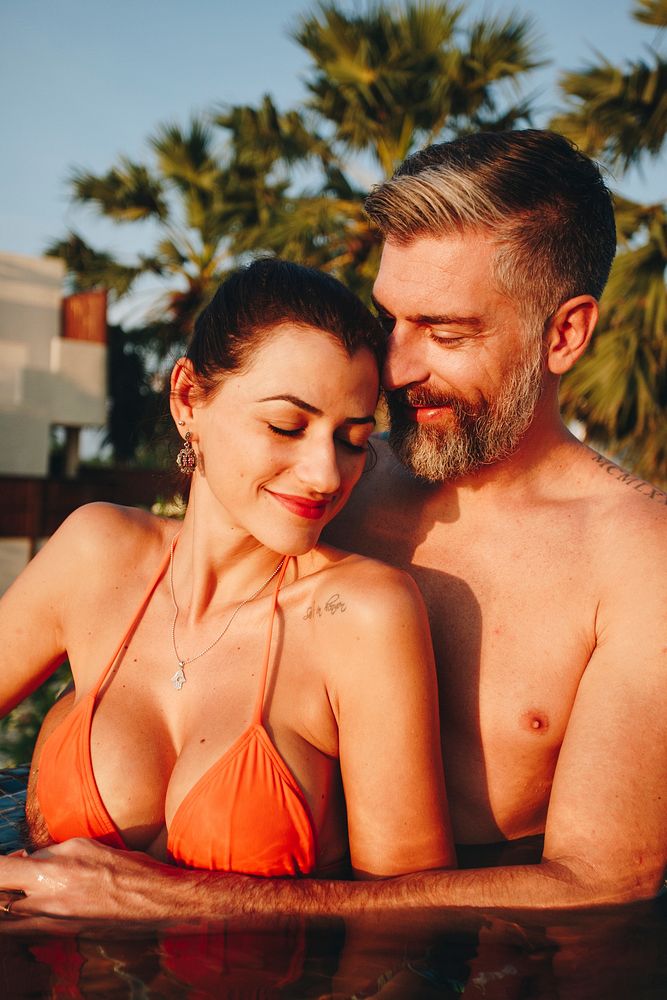 Honeymooners in a swimming pool at a resort