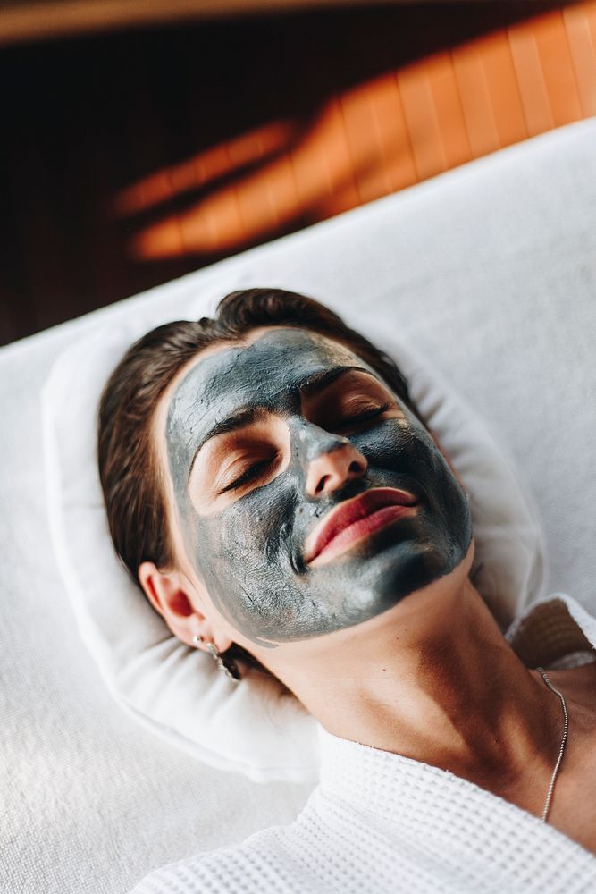 Woman relaxing with a facial mask at the spa