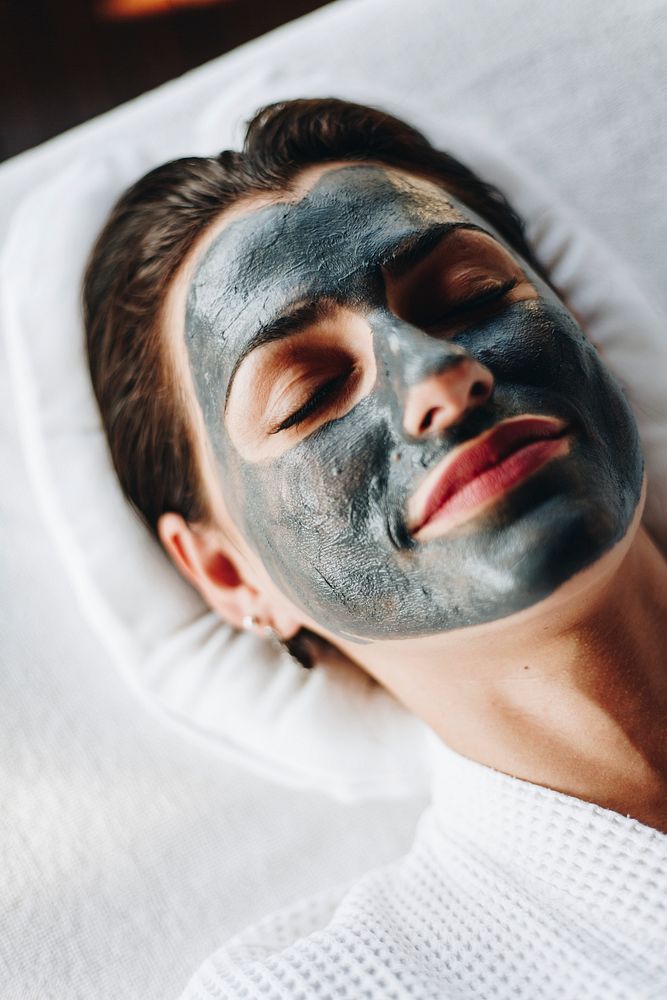 Woman relaxing with a facial mask at the spa