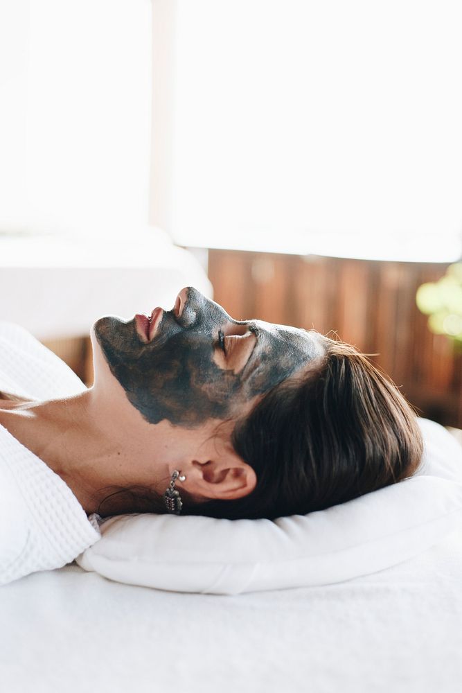 Woman relaxing with a facial mask at the spa