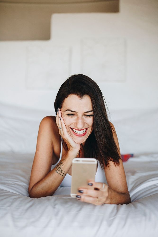 Woman using a mobile phone in bed