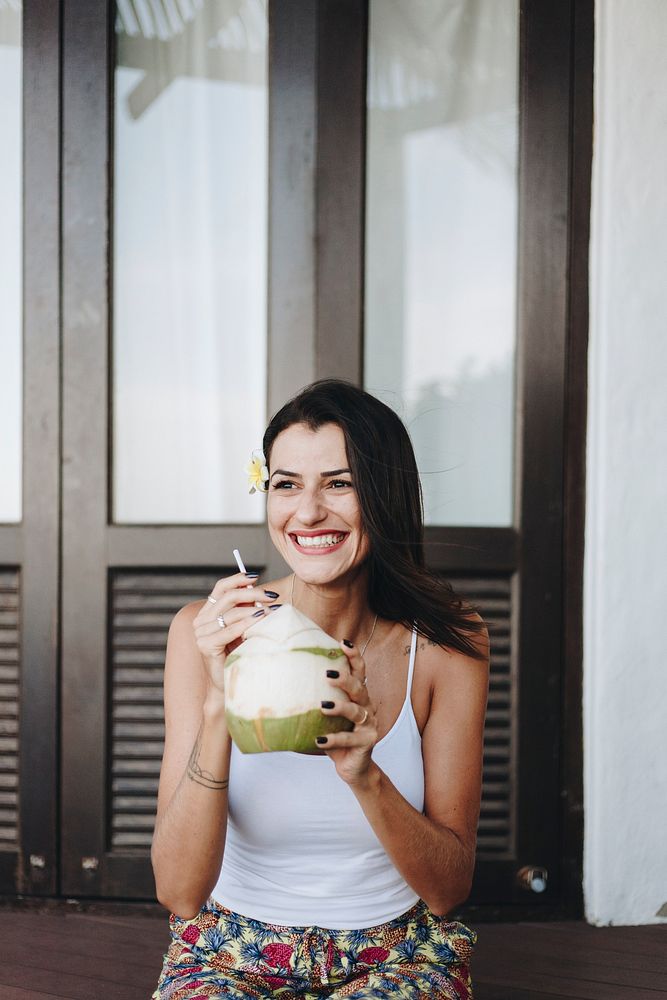 Woman drinking a fresh coconut