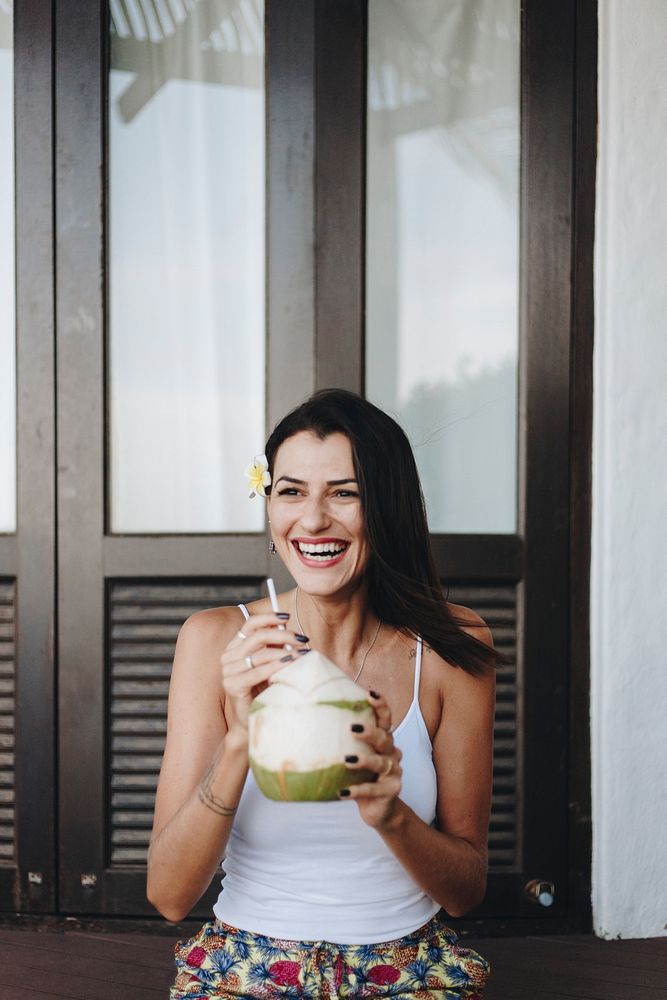 Woman drinking a fresh coconut