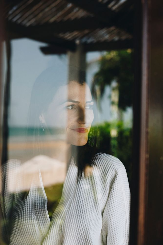 Woman looking out her hotel room window