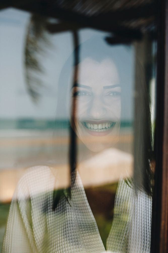 Woman looking out her hotel room window
