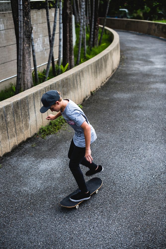 Young boy skateboarding in the street