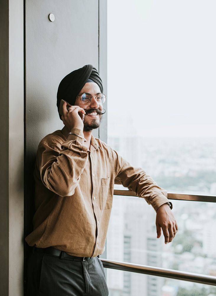 Indian businessman on the phone with cityscape background