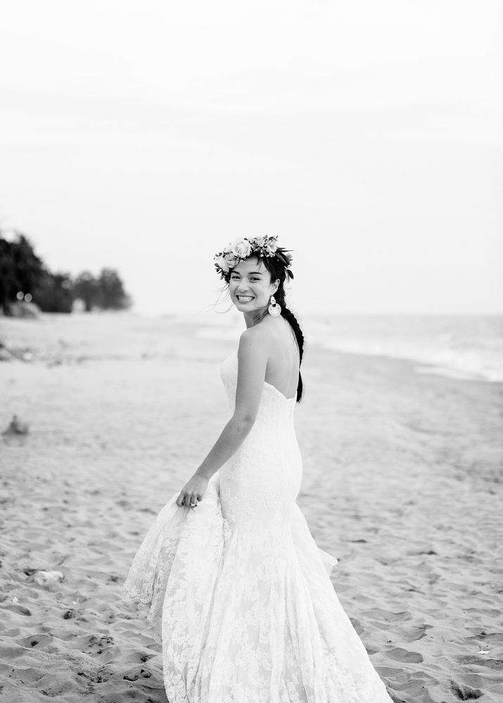 Young bride in her wedding dress on the beach