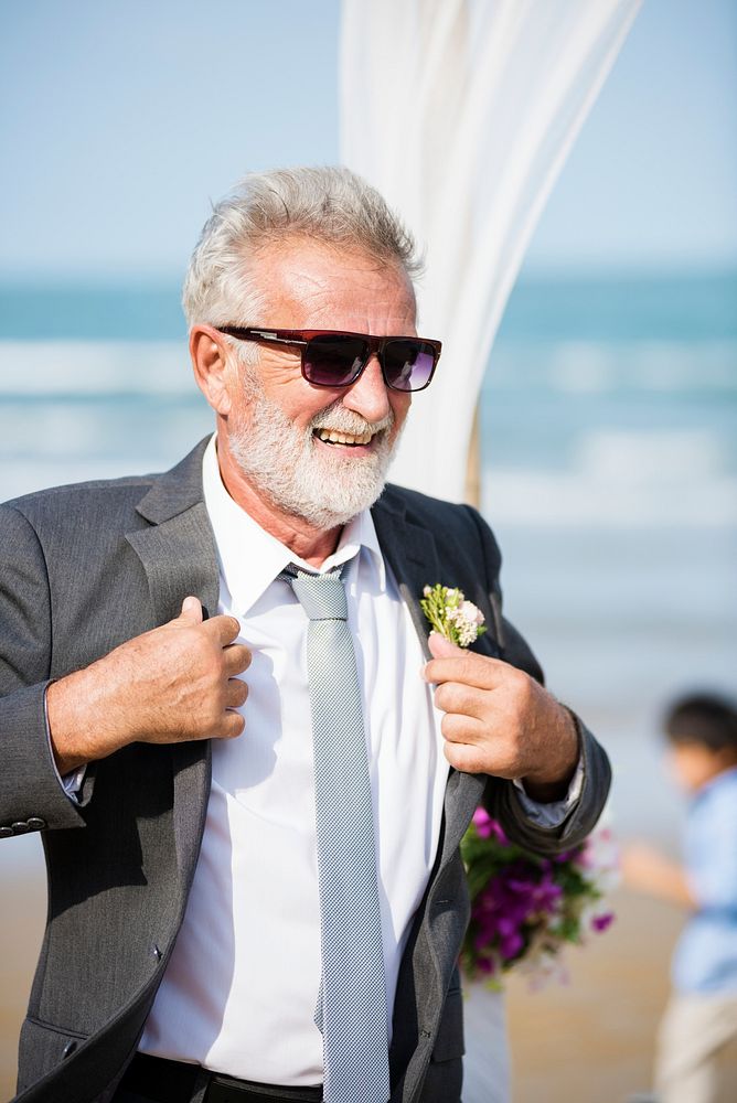 Senior groom at beach wedding