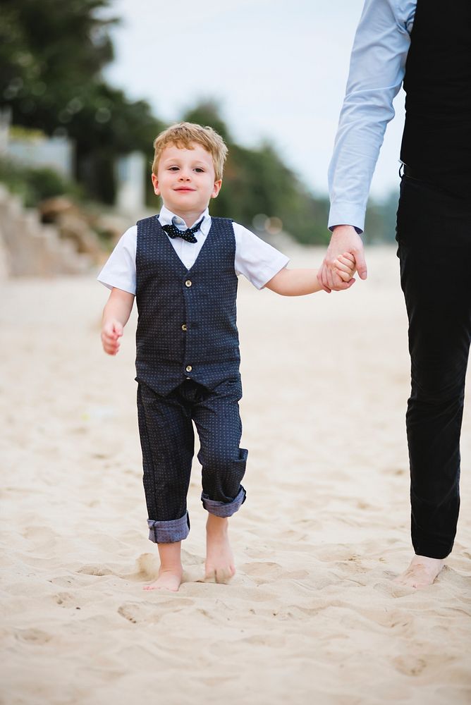 Father and son at a beach wedding