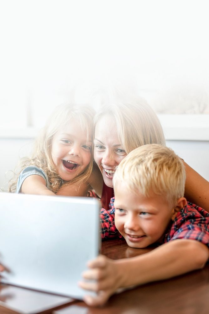 Blonde mom and kids making a video call on a tablet blank space 