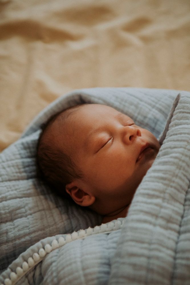 Infant baby fast asleep on the bed