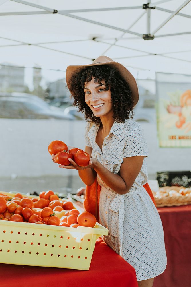 Woman buying tomatoes at a farmers market