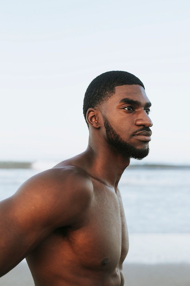 Fit man posing at the beach