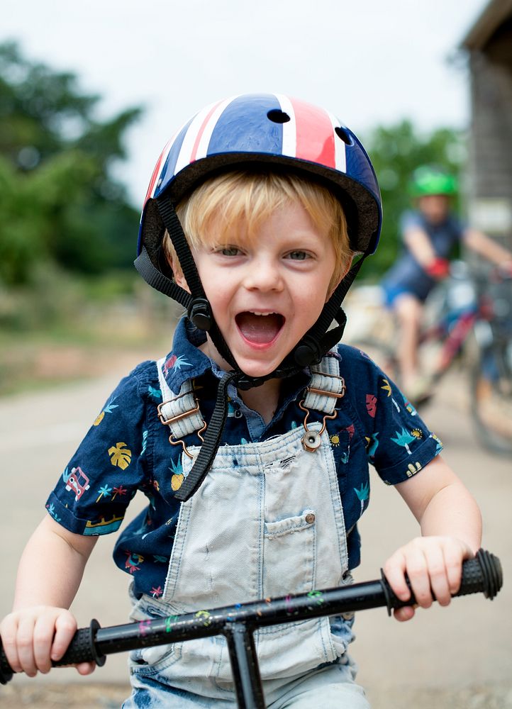 A young boy riding his bike