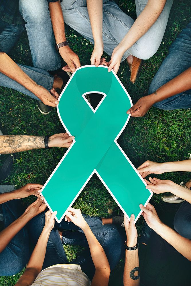 Group of people holding a green colored ribbon