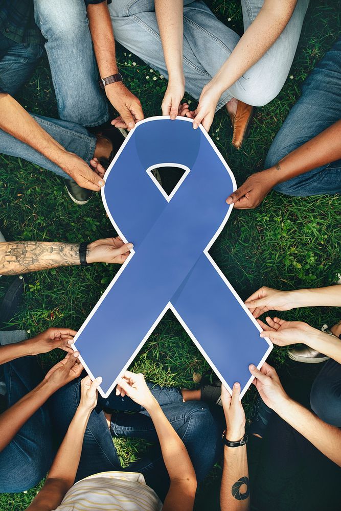 Group of people holding a blue colored ribbon