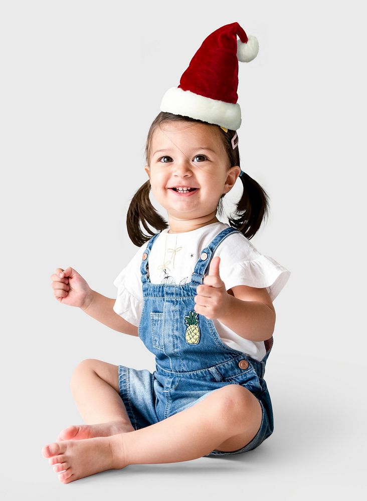 Cheerful little girl wearing a Christmas hat