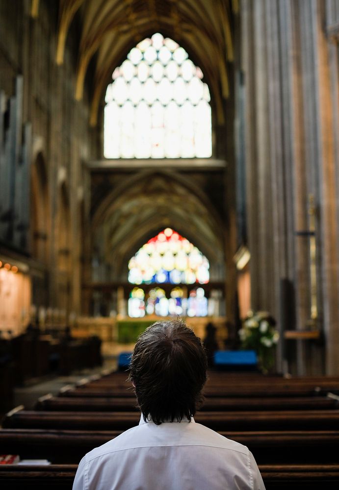 Man praying alone at church
