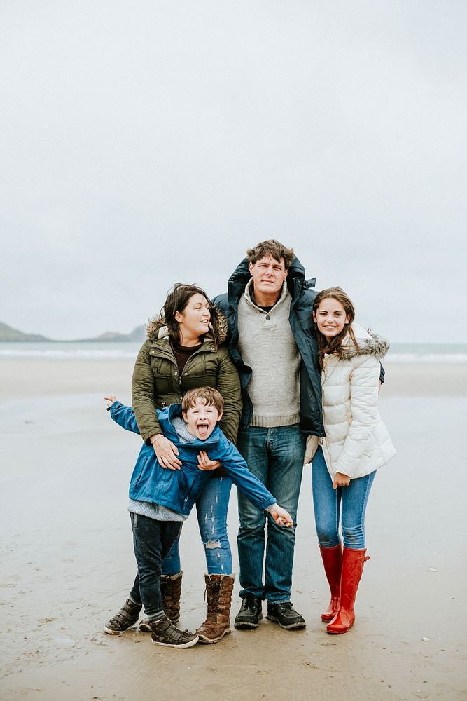 Cheerful family portrait at the beach
