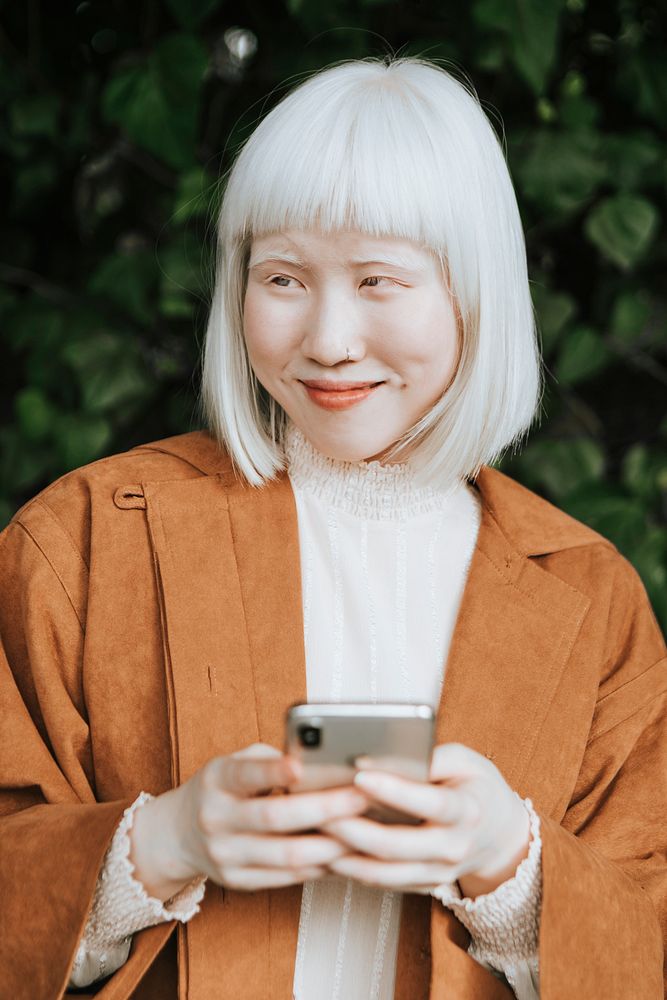 Cute albino girl texting on her phone