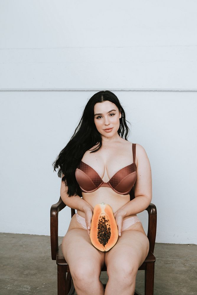 Partially nude woman with a papaya