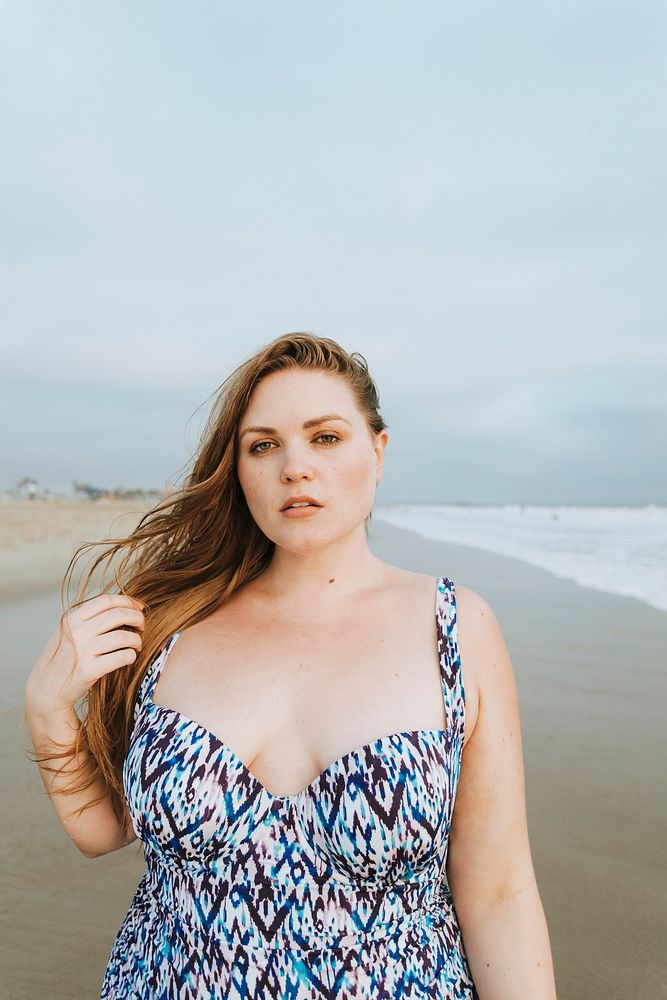 Confident blond plus size woman at the beach