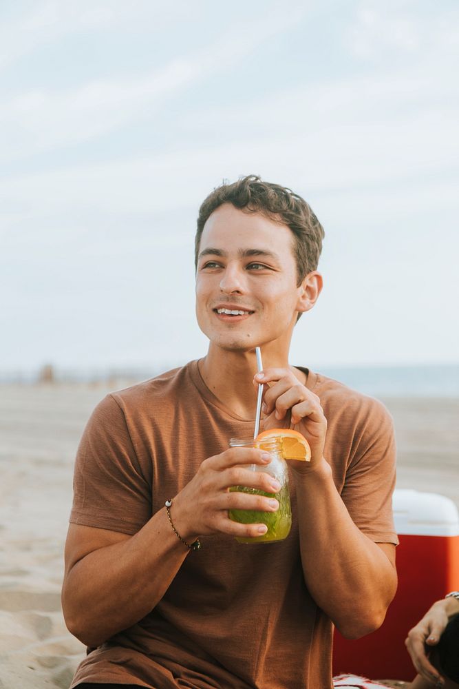 Man drinking a mojito at a beach party