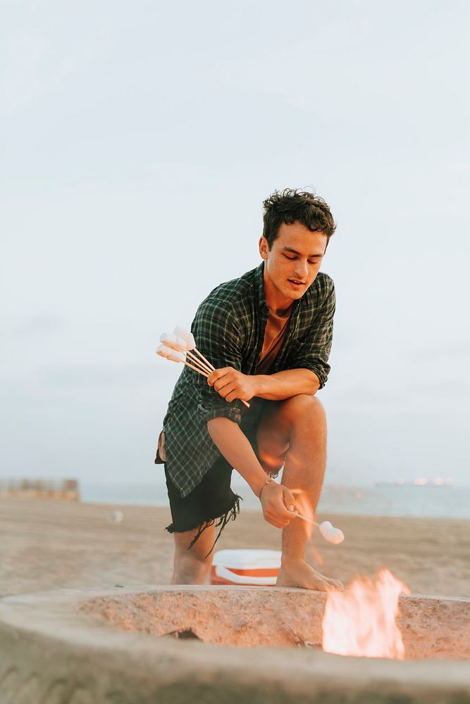 Man roasting marshmallows over a bonfire