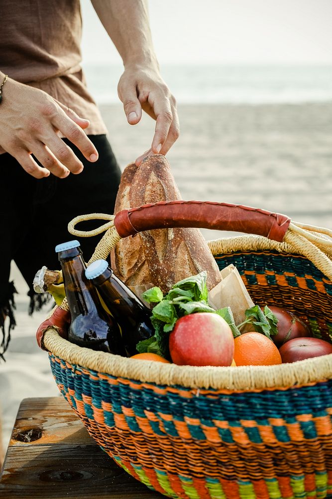 Man getting food from a picnic basket