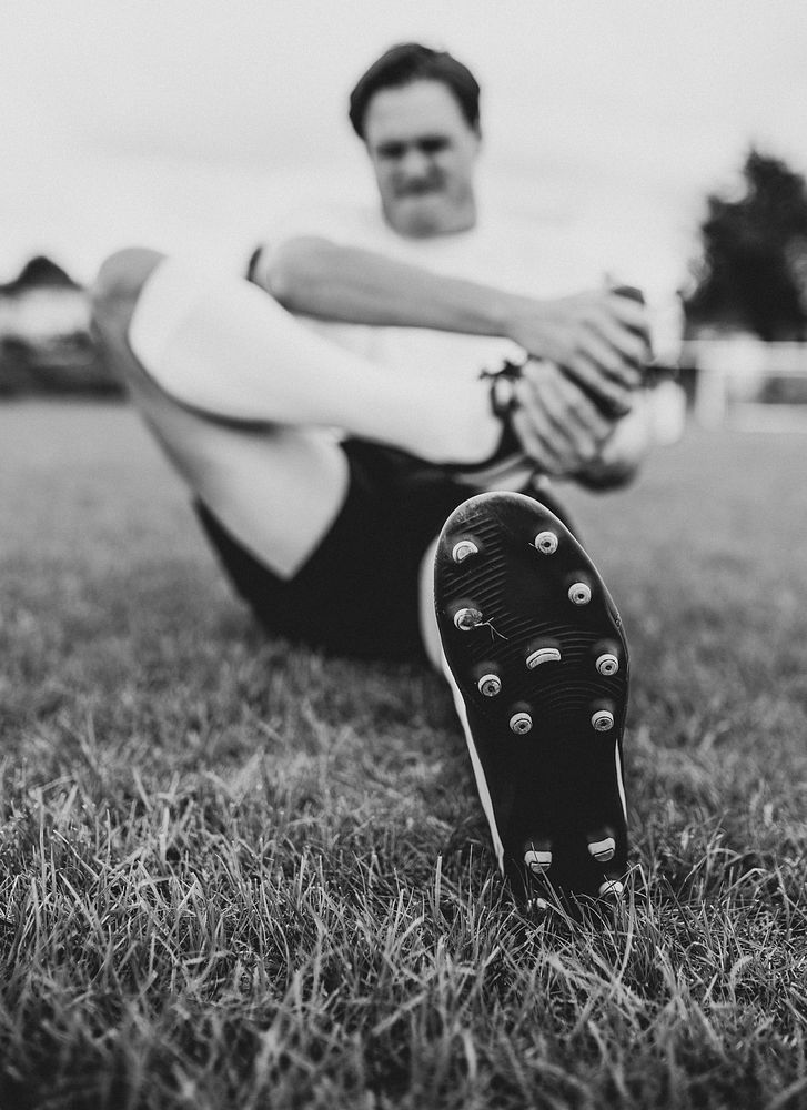 Football player stretching before a match