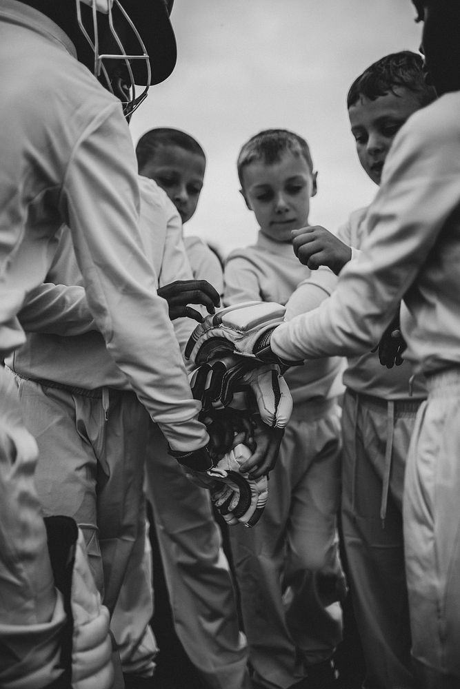 Young cricketer stacking their hands together