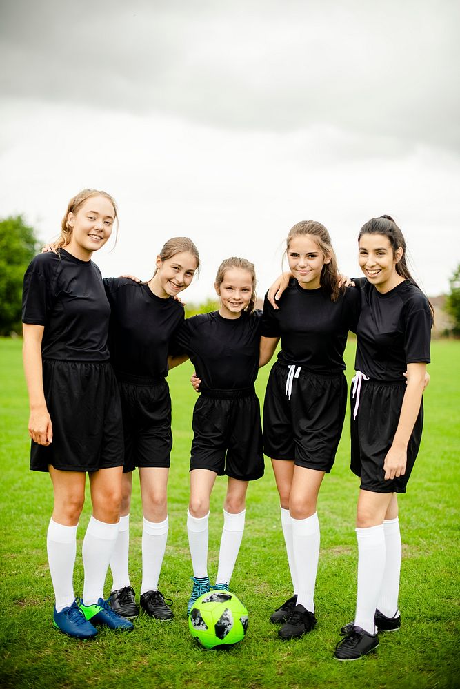 Female football players huddle before a match