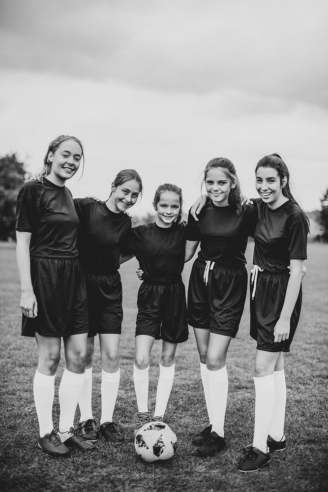 Female football players huddle before a match