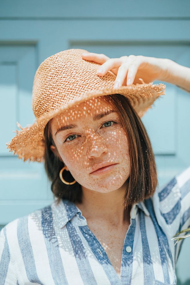 Portrait of a young woman with freckles
