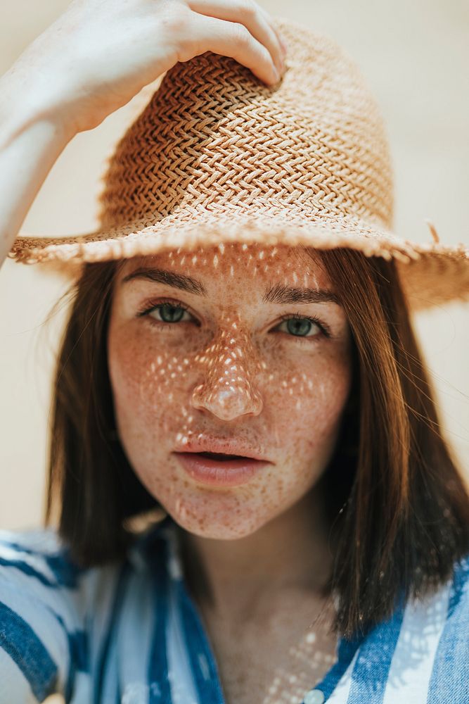 Portrait of a woman wearing a straw hat