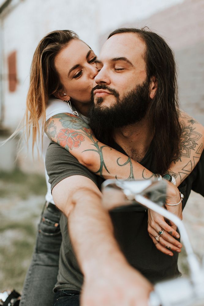 Girlfriend hugging her biker boyfriend