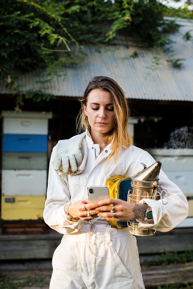 Beekeeper texting on her phone