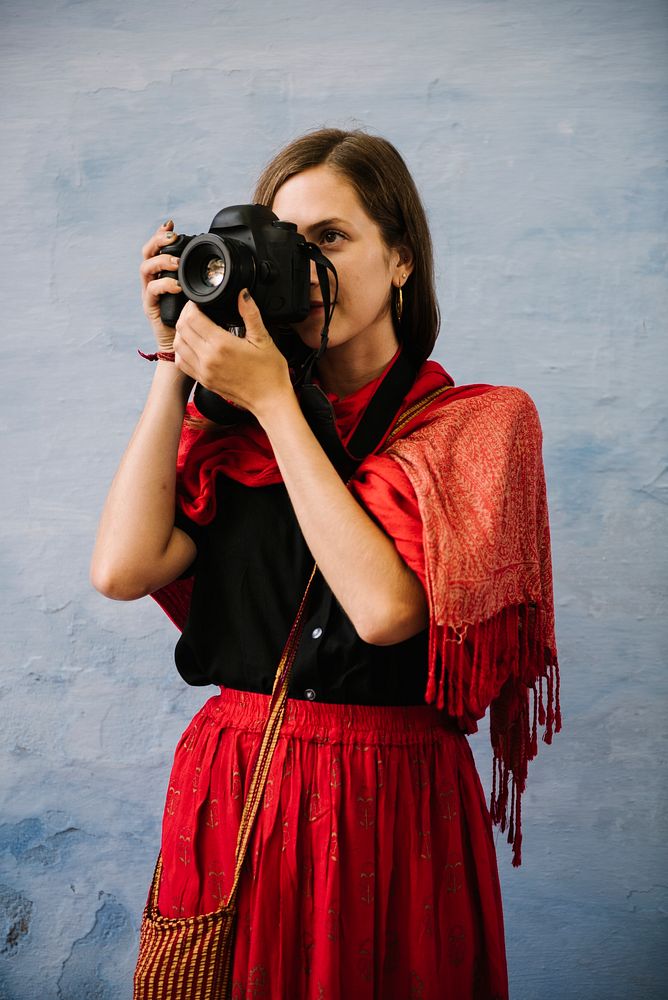 Western female photographer exploring a city of Udaipur, India