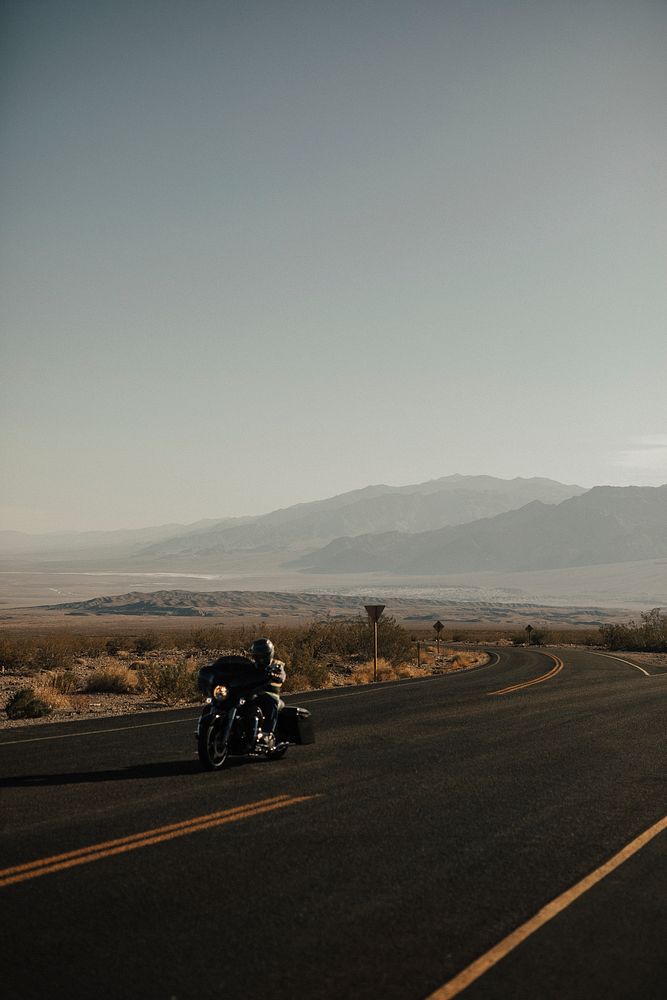 Man riding a motorcycle on a scenic route in USA