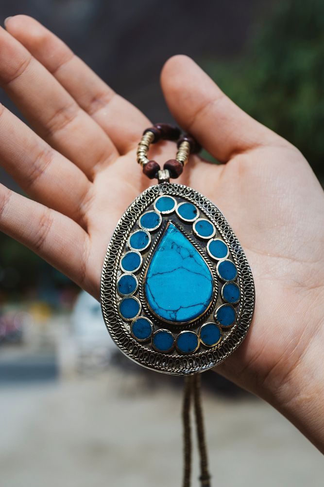 Woman holding a vintage gem necklace