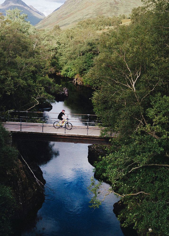 Cyclist biking over a bridge