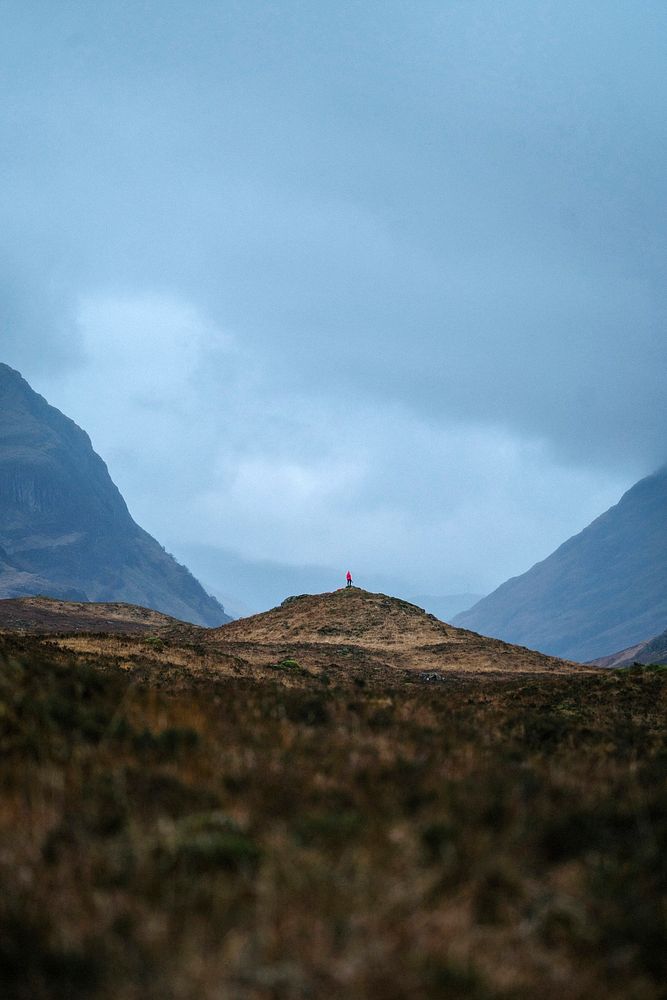 Female photographer on top of a hill at Glen Etive, Scotland