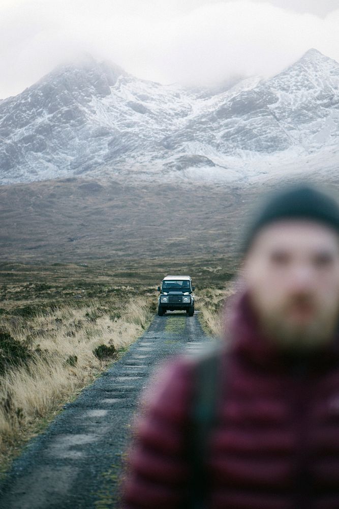 Man walking away from his car at Glen Etive, Scotland