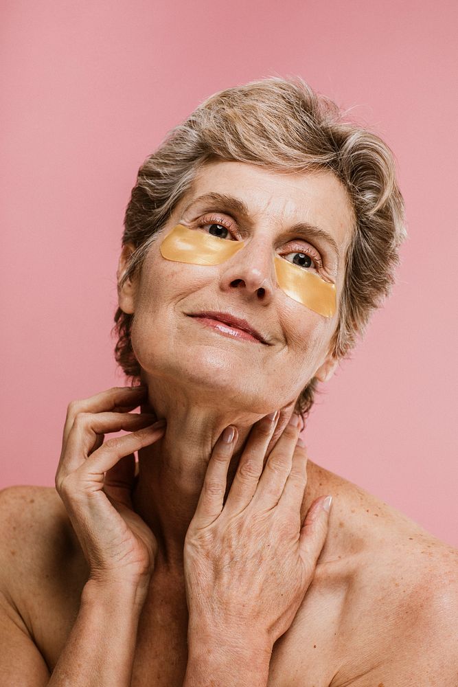 Senior woman relaxing with a golden eye mask