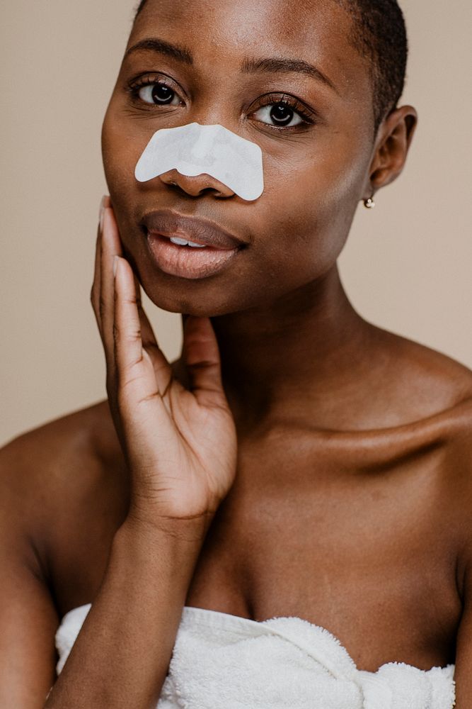 Black woman with a nose pore strip