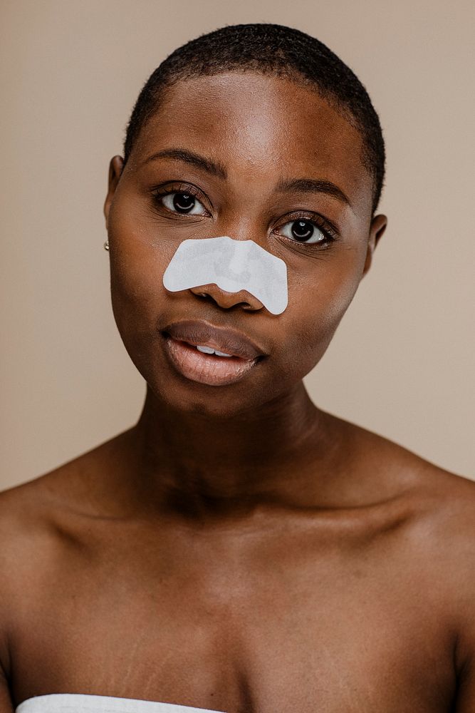 Black woman with a nose pore strip