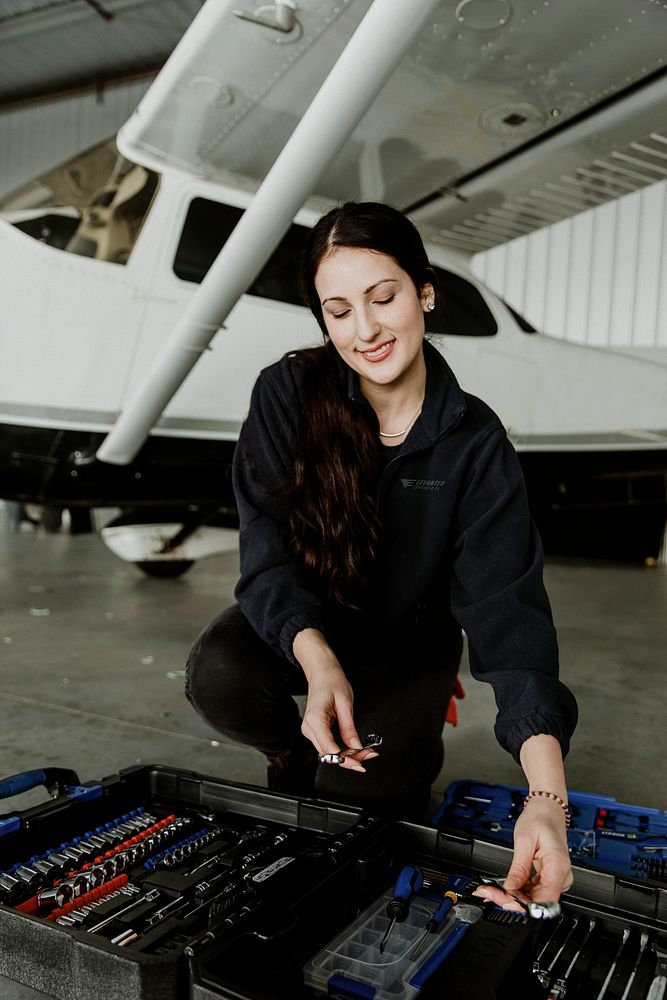 Female aviation technician with her tool box