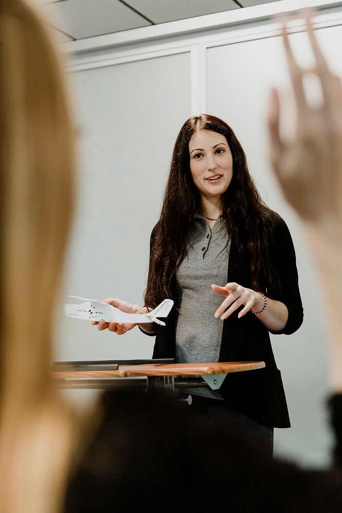Woman explaining aerodynamics in a classroom