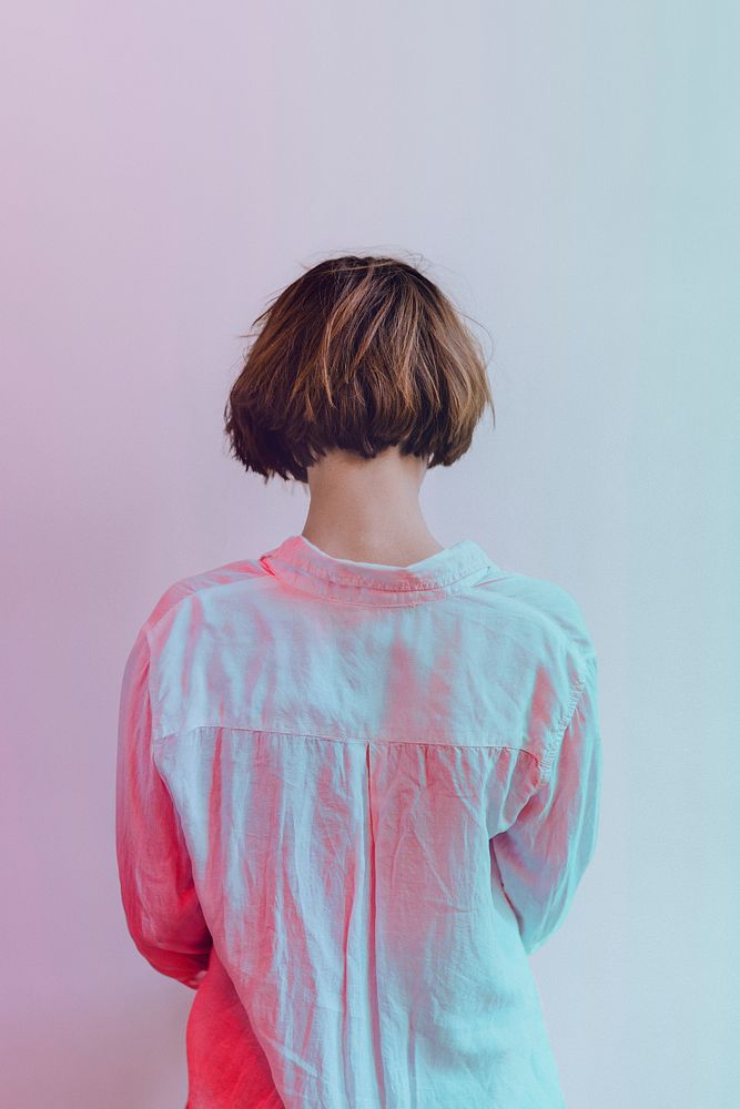 Rear view of a short dyed hair in a white shirt